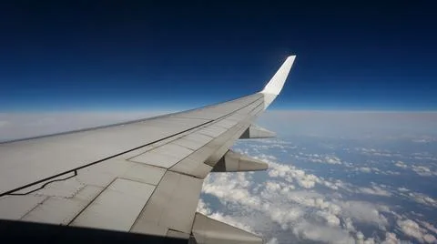 Clouds and sky as seen through window of an aircraft Stock Photos