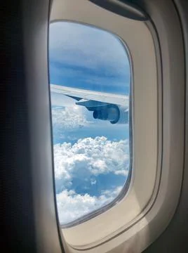 Clouds and sky as seen through the window of an aircraft Stock Photos