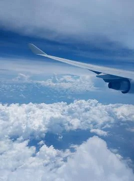 Clouds and sky as seen through the window of an aircraft Stock Photos