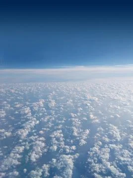 Clouds and sky as seen through the window of an aircraft Stock Photos