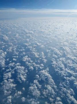 Clouds and sky as seen through the window of an aircraft Stock Photos