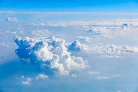 Clouds and sky as seen through window of an aircraft. Stock Photos