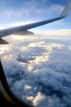 Clouds and sky as seen through window of an airplane during flight Foto stock