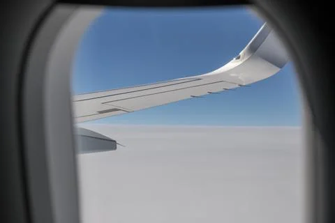 Clouds and sky as seen through window of an aircraft. Stock-Fotos