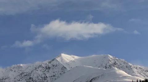 Clouds and Spindrift Pulsing over Snowy Crag Mountain Stock-Footage 11017201