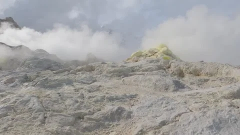 Clouds and steam drifting over a volcano sulfur pot Stock Footage 245038580