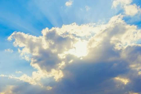 Clouds and sun rays and blue sky Stock Photos