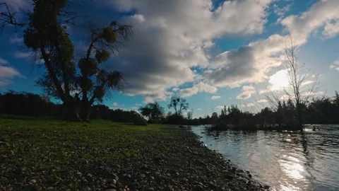 Clouds and sun reflect across the American River at River Bend Park Stock Footage 325068864