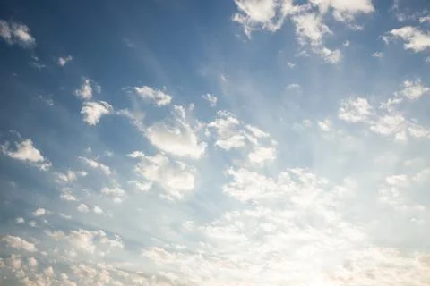 Clouds and sunrays at sunrise Stock Photos