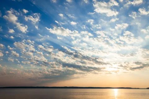 Clouds and sunrays at sunrise Stock Photos
