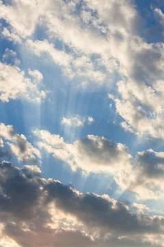Clouds and sunrays at sunrise Stock Photos
