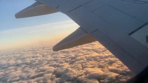 Clouds and sunshine seen from airplane window Stock Footage 123851721