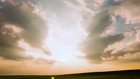 Clouds and Traces of Planes on a Background of a Sunset. Time Lapse 4K 動画素材 106453677