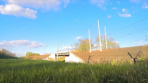 Clouds and trains on rails in spring timelapse Stock Footage 82988063