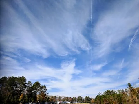 Clouds and vapor trails in the summer. Stock Photos