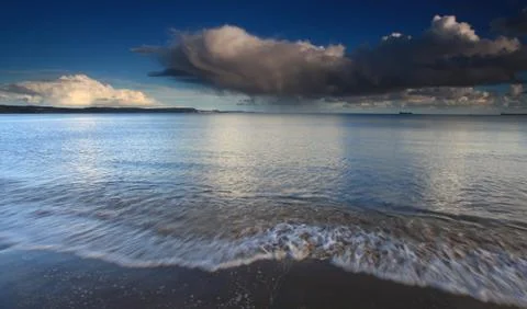Clouds and waves Stock Photos