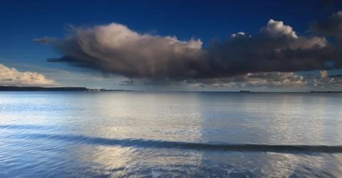 Clouds and waves Stock Photos