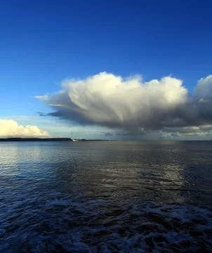 Clouds and waves Stock Photos