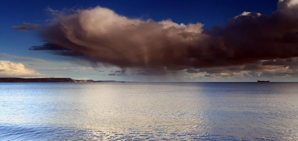 Clouds and waves Stock Photos