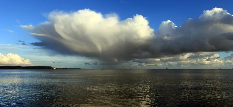 Clouds and waves Stock Photos