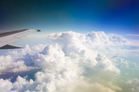 Clouds and wing of the plane Stock Photos