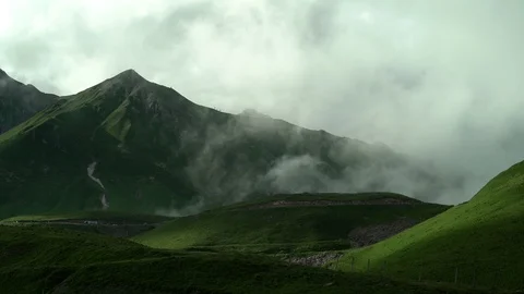 Clouds are approaching the sky road with moving cars between the green tops. Stock Footage 115963391