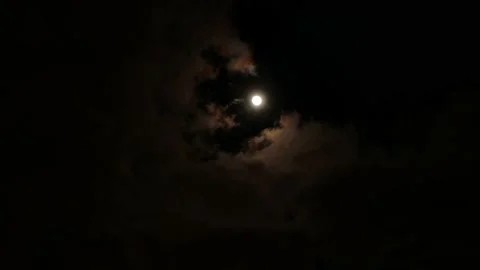 Clouds are drifting across the sky on the background of glowing full moon Stock Footage 149408816