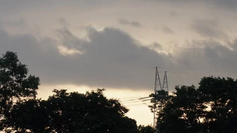 The clouds are floating in the sunset sky with silhouette of trees Stock Footage 316240511