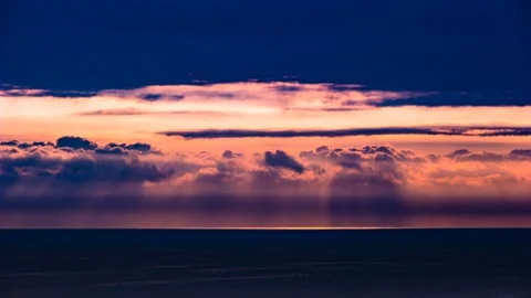 The clouds are flowing under the red sunshine above the sea. Time lapse 스톡 동영상 145739207