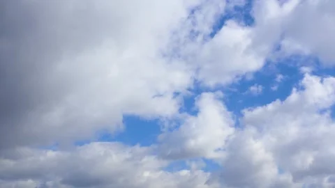 Clouds are flying across the blue sky. Timelapse 動画素材 332159626