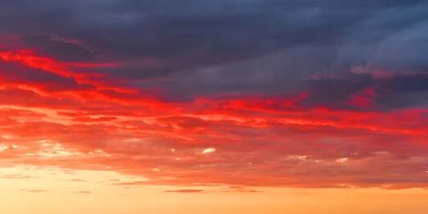 The clouds are lit by the rays of the evening sun Stock Photos