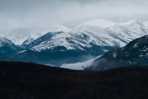 Clouds are low in front of mountains covered with snow in Pyrenees Stock Photos