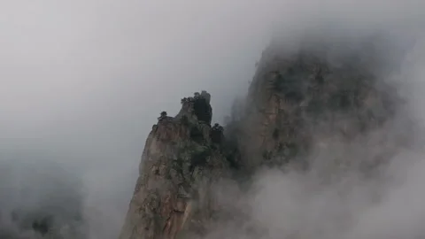 Clouds are moving around the peak of a mountain Stock Footage 289664261