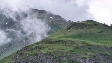 Clouds are moving over a green mountain peak Stock Footage 289681123