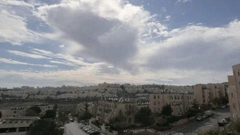 Clouds are moving over the roofs of the residential area in Jerusalem. 스톡 동영상 84731655