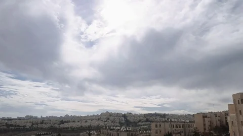 Clouds are moving over the roofs of the residential area in Jerusalem. 스톡 동영상 84735403