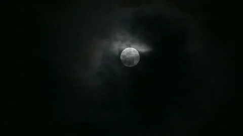 Clouds are moving through the full moon, the atmosphere looks mysterious and Video stock 163363189