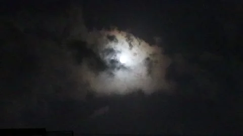 Clouds are moving through the moon at during night with a full moon Video stock 151495624