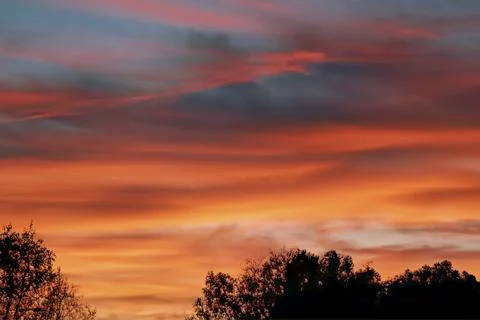 The clouds are multicolored, thunderous bizarre shapes against the blue sky Stock Photos