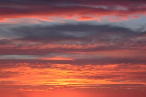The clouds are multicolored, thunderous bizarre shapes against the blue sky Stock Photos