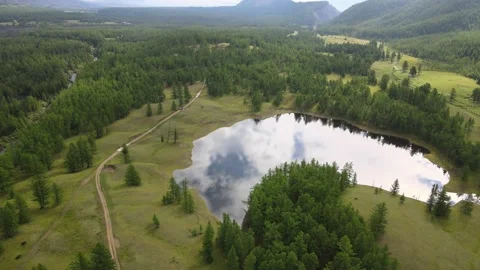 Clouds are reflected in mountain lake. Aerial view. Stock Footage 170042874
