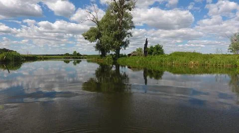 Clouds are reflected in the river, blue sky in the lake Stock Photos