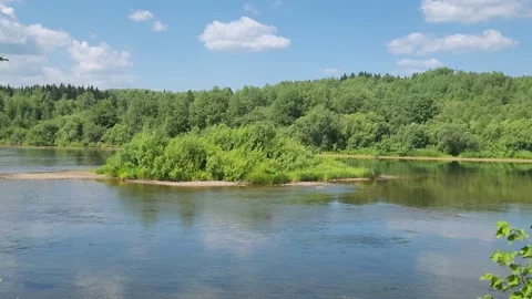 Clouds are reflected in the river. Forest on the river bank. Beautiful landscape Stock Footage 245275316