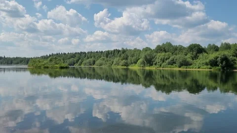 Clouds are reflected in the river. Forest on the river bank. Beautiful landscape Stock Footage 245403255