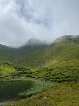 Clouds are rolling through after the rain in the Carpathian Mountains in Ukra Stock Photos