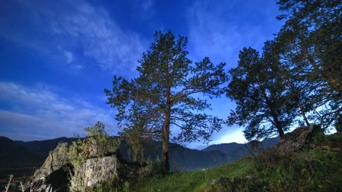 Clouds are running through the sky in the mountains at night. Stock Footage 90560564