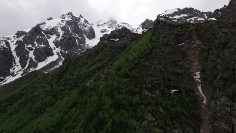 Clouds are slowly passing over a snowy mountain peak Stock Footage 289651324