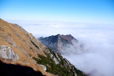 Clouds around the mountainsides of high mountain Stock Photos