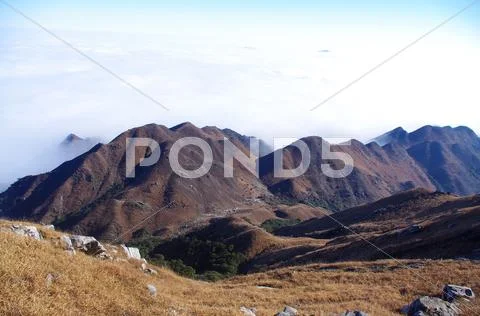 Clouds around the mountainsides of high mountain Stock Photos