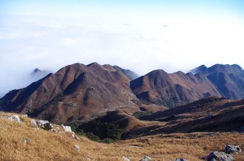 Clouds around the mountainsides of high mountain Stock Photos